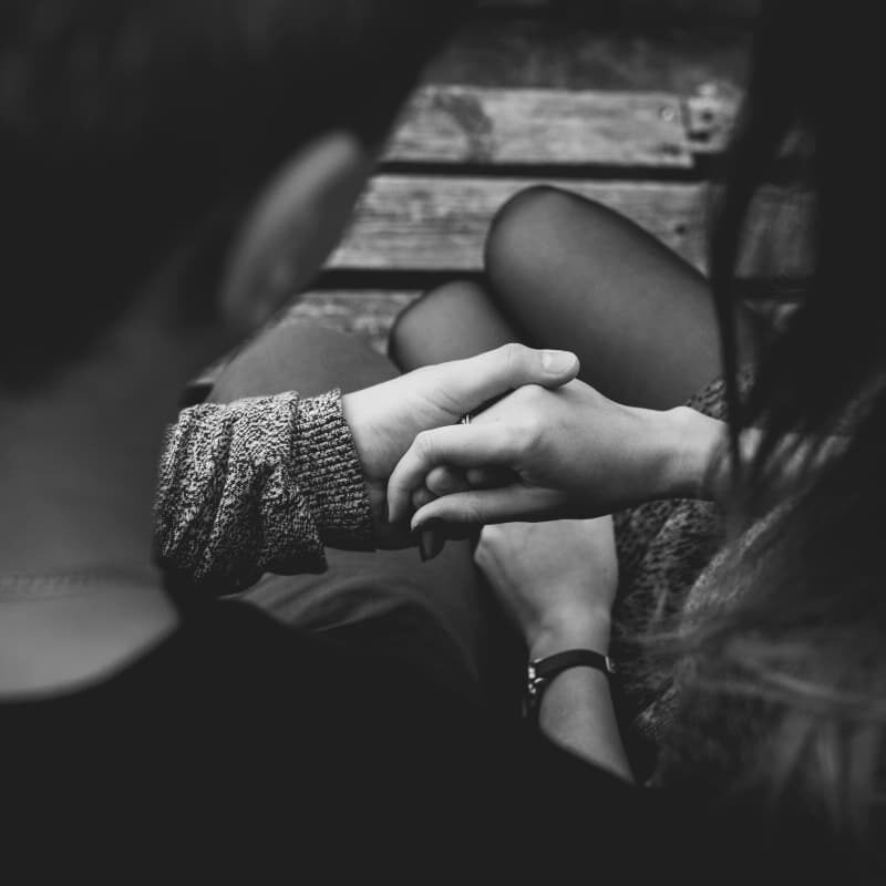 Two people sitting on a couch with engaged in a conversation about BPD relationship treatment and management.