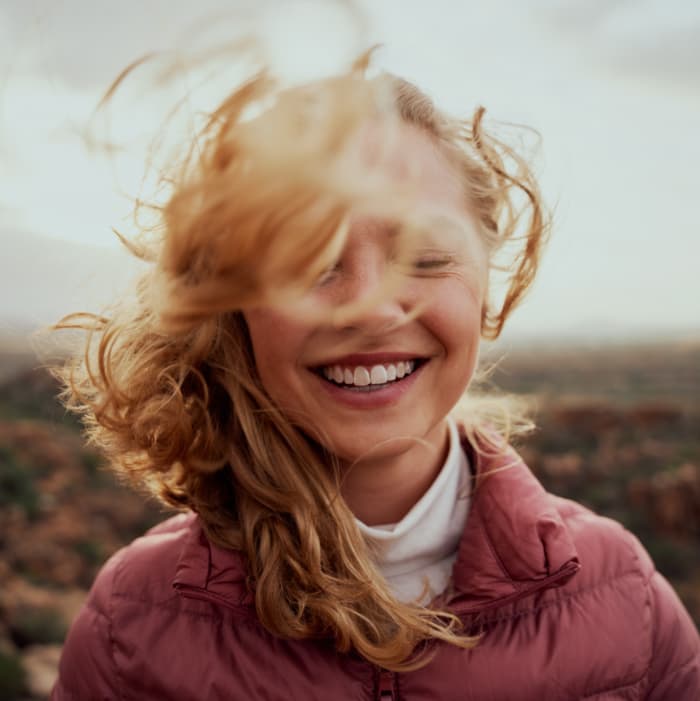 Close-up of a smiling woman's face, symbolizing the hope and positivity that can be found through seeking help for substance use disorders.