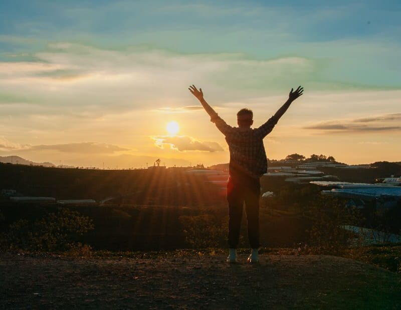 Silhouette of a man with outstretched arms, symbolizing contemplation and reflection on despair.