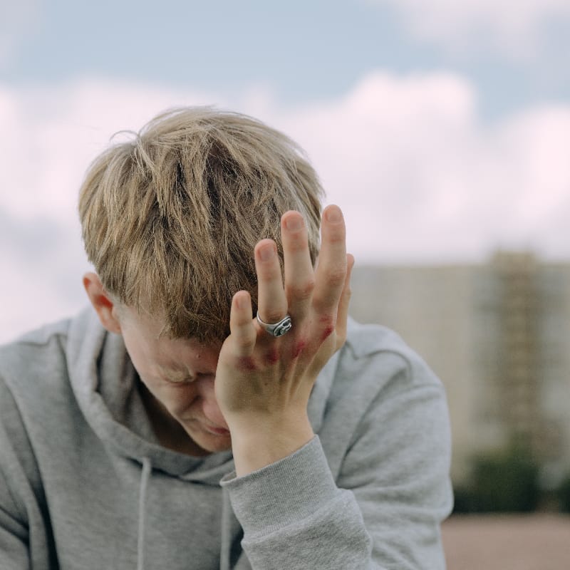 Man experiencing intense headache, a potential symptom of Somatoform Disorder.