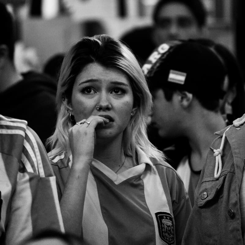 Young girl biting her lip in worry, a visual portrayal of the internal struggles faced in understanding neurotic behavior.