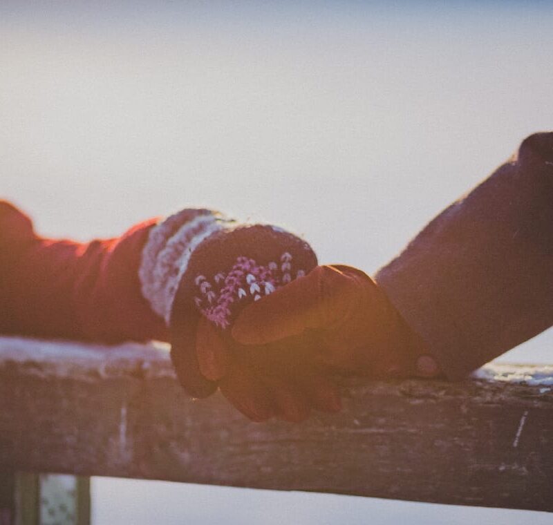 Two hands side-by-side wearing gloves, representing the protective barriers people erect even amidst signs of a codependent relationship.