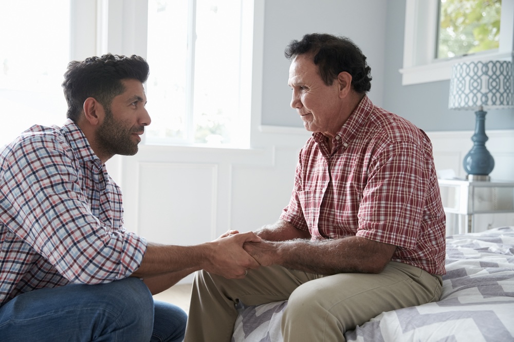 Adult man talking to his senior father who is dealing with grief and depression