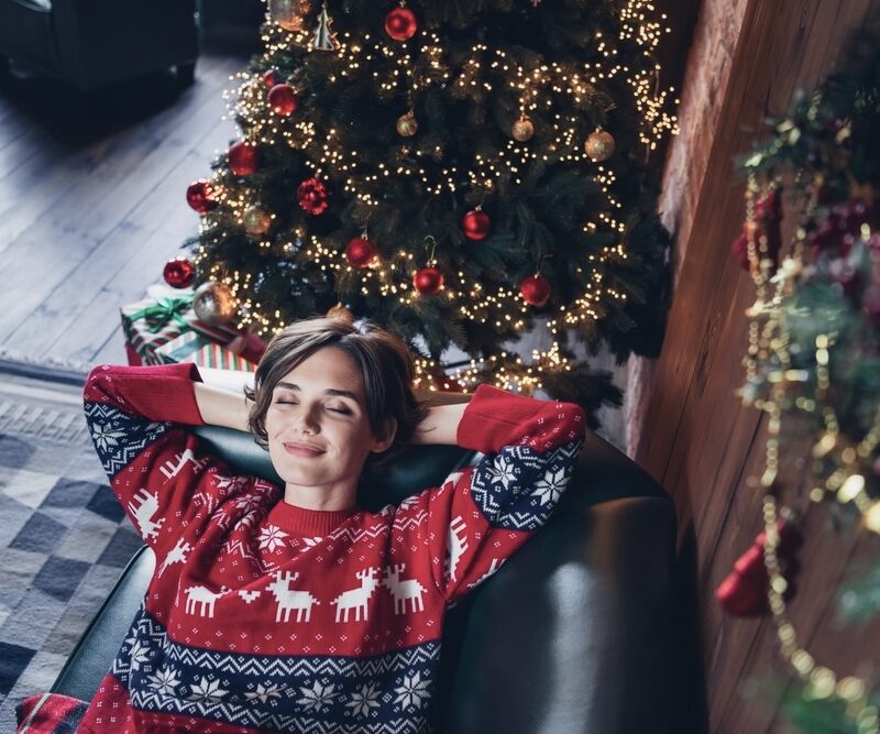 Woman lying down on the couch with a calm, contented face