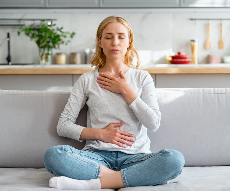 Female practicing deep breathing to avoid anxiety