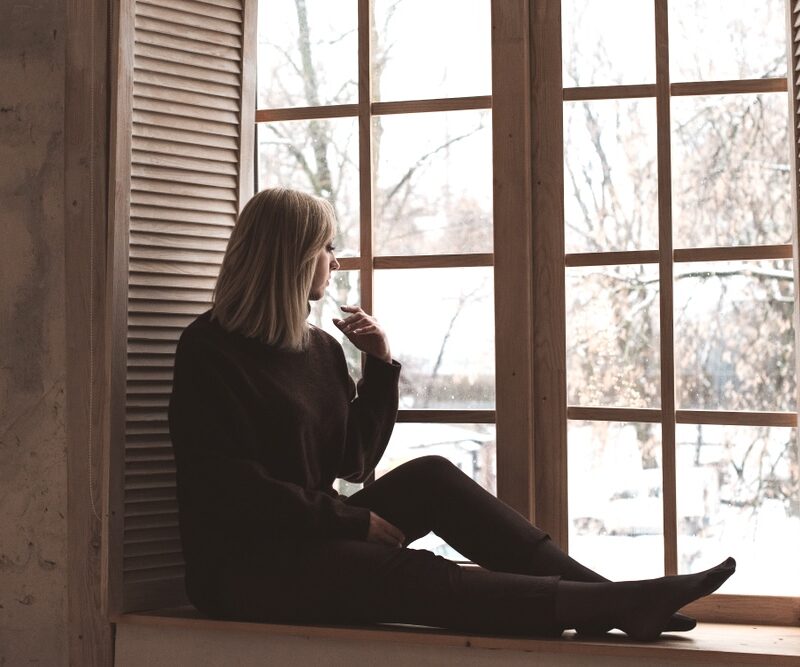 Woman being affected by seasonal affective disorder or SAD during winter