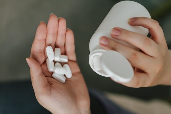 Woman pouring Xanax pills on her hand