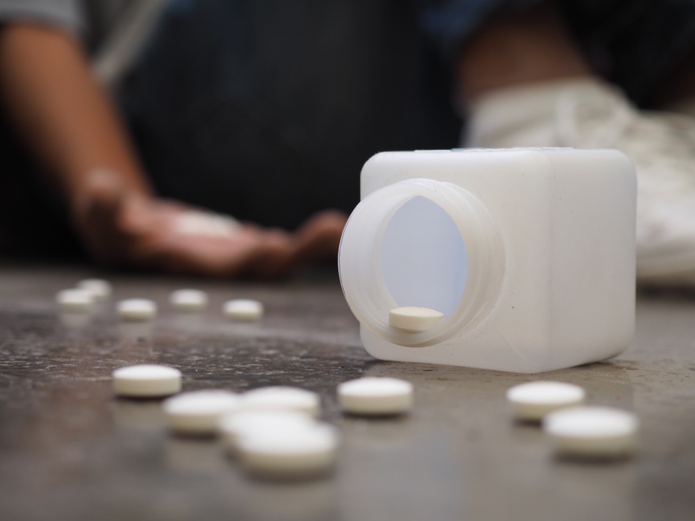 Xanax pills on the ground spilled from the bottle